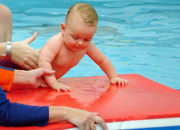 baby swimming with float