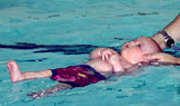 baby swimming on back