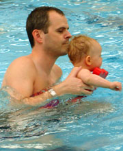 baby and dad swimming