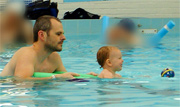 picture of baby swimming using woggle